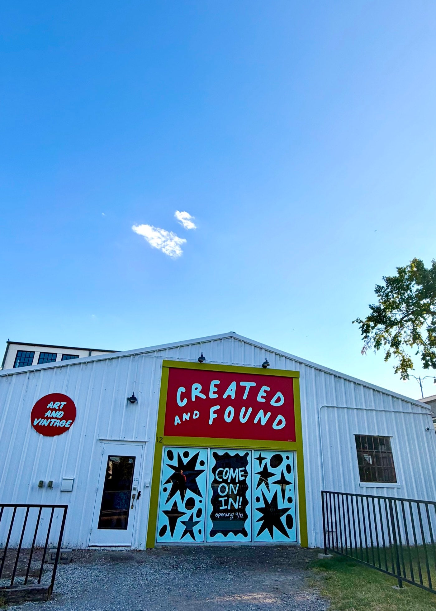 The Created and Found shop front: a white barn-style building with a red sign and painted doors reading "Come on in!"